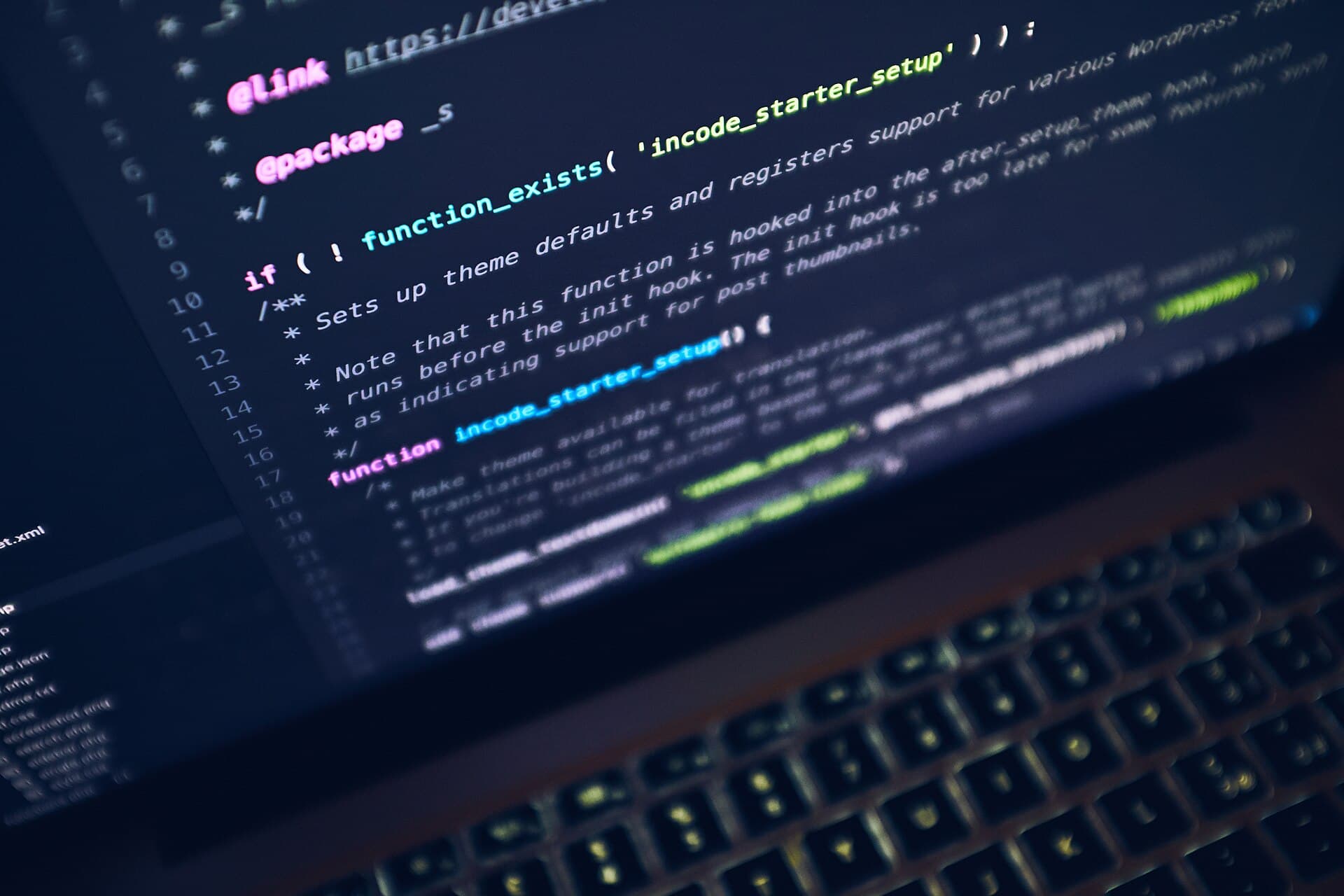 A laptop screen showing source code in a dark editor